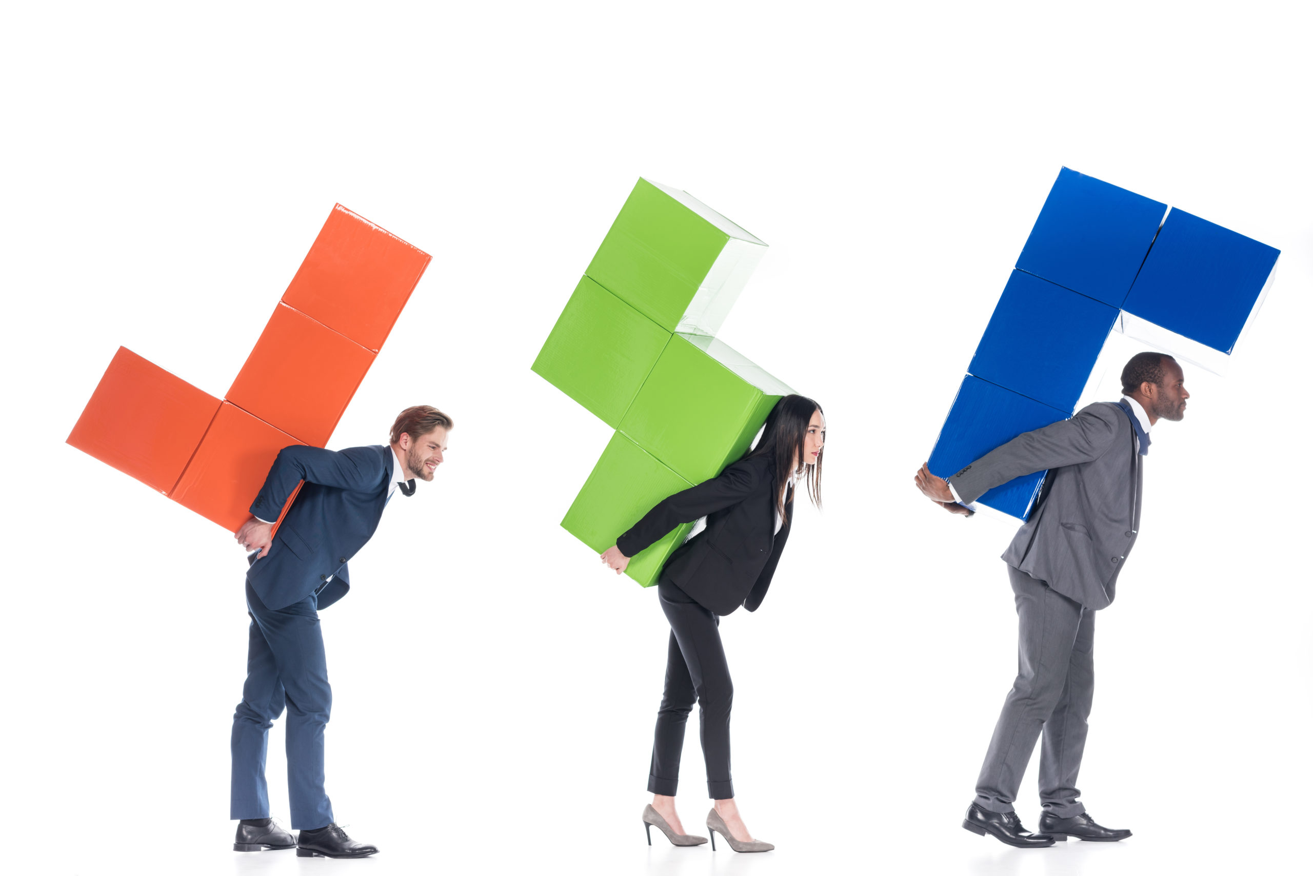 side view of multicultural business colleagues holding colorful blocks isolated on white, business